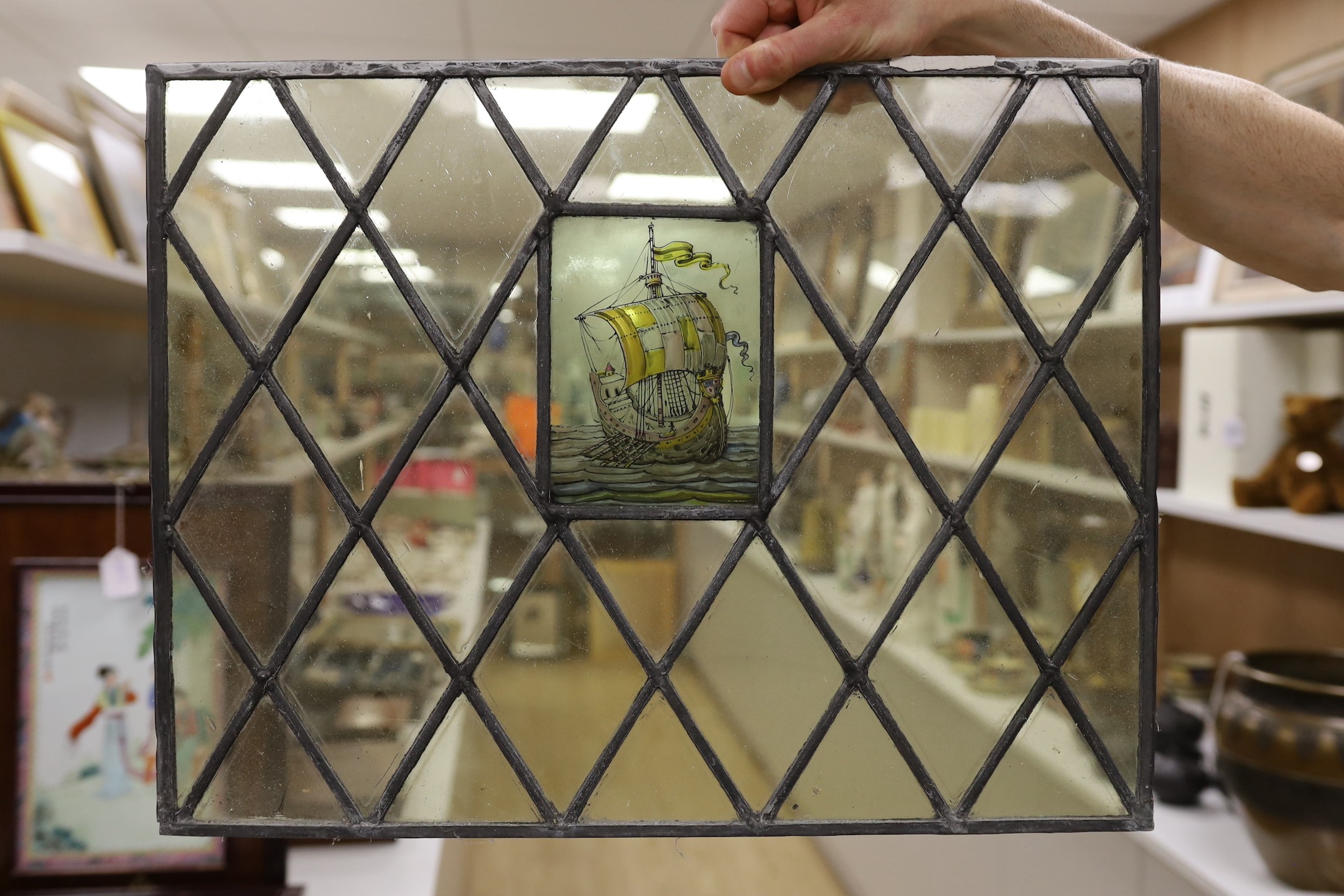 Four late 19th century leaded and stained glass panels, various sizes, with central cartouche 53cms wide x 41cms high